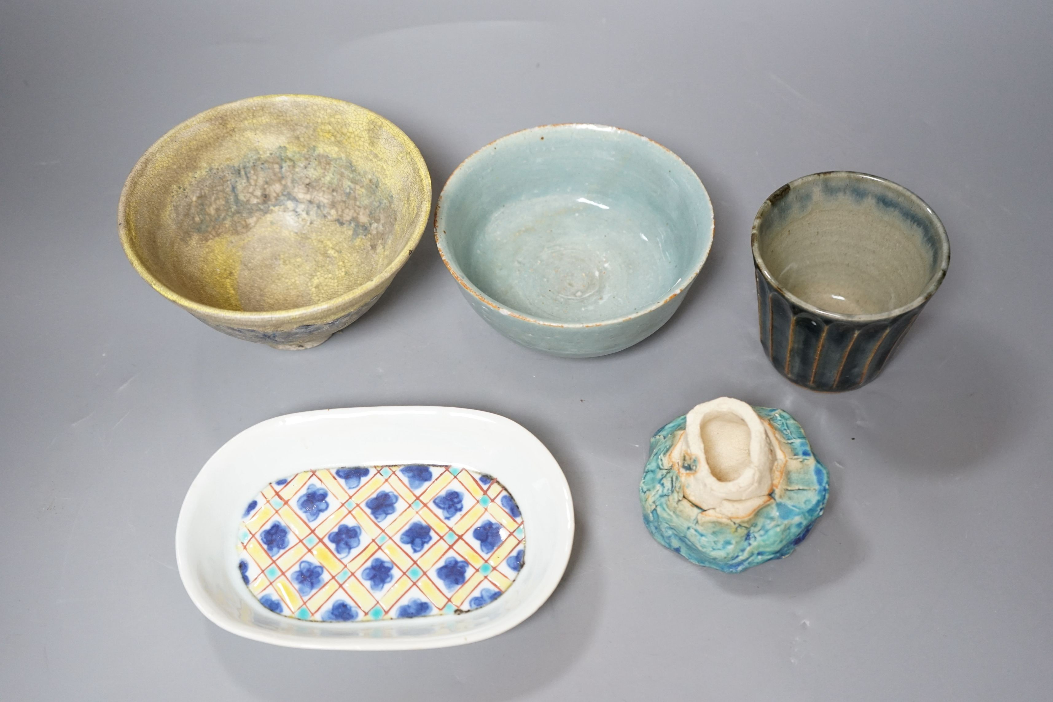 Japanese studio pottery; a group to include two bowls, and a plum dish, a fluted cup and a brushwasher, tallest 8cm, (5)